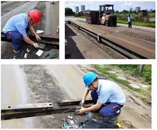 圖為工作人員正在對(duì)一號(hào)電子地磅進(jìn)行維修